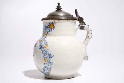 An Italian maiolica compendario style jug with a putto, Faenza, 17th C.