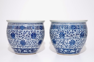 A pair of Chinese blue and white lotus scroll fishbowls, 19th C.