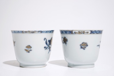 A pair of Chinese blue, white and gilt cups and saucers, Qianlong