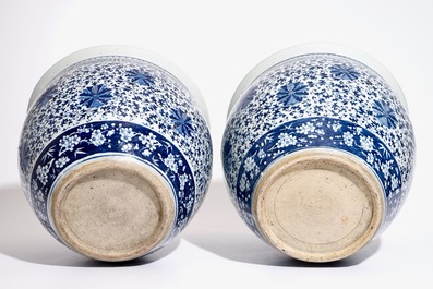 A pair of Chinese blue and white lotus scroll fishbowls, 19th C.