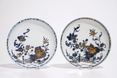 A pair of Chinese blue, white and gilt cups and saucers, Qianlong