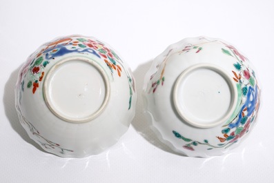 A pair of Chinese famille rose cups and saucers with peacocks, Qianlong