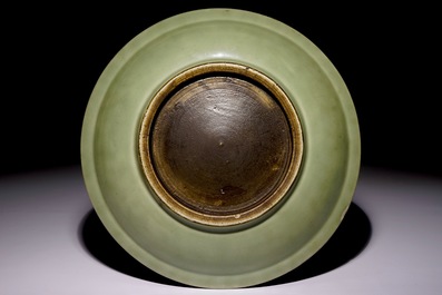 A Chinese celadon dish with incised lotus design, 19th C.