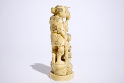 A Japanese ivory okimono of bird catchers, Meiji, early 20th C., signed