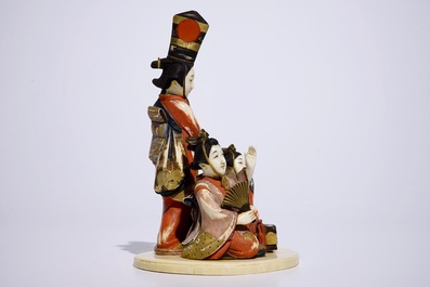 A polychrome Japanese ivory okimono of ladies presenting a gift, Meiji, early 20th C.