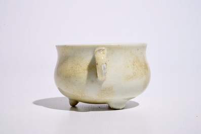 A Chinese crackle glazed blanc de Chine two-handled tripod incense burner, Kangxi