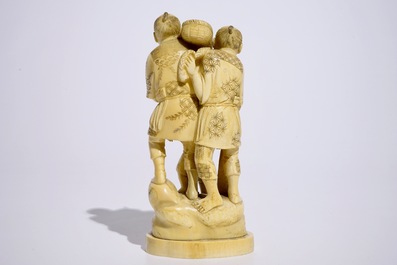 A Japanese ivory okimono of bird catchers, Meiji, early 20th C., signed