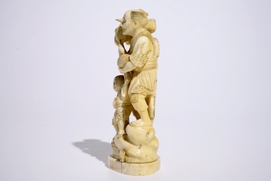 A Japanese ivory okimono of bird catchers, Meiji, early 20th C., signed