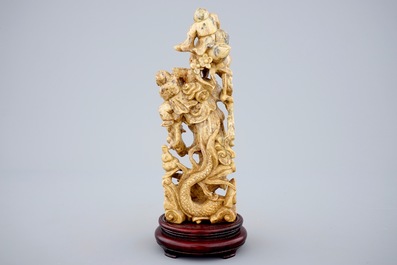 A Chinese soapstone figure of Buddha with laughing boys, 19/20th C.