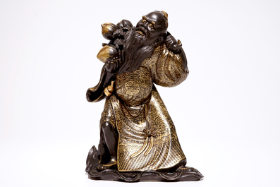 An unusual Chinese black-glazed and gilt model of Shou Lao, 19/20th C.