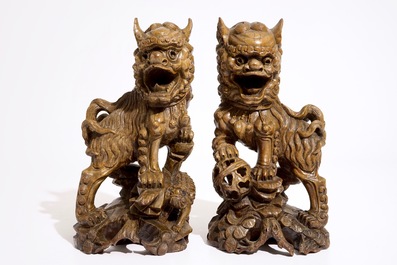 A pair of Chinese carved wood figures of temple lions, 19/20th C.