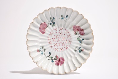 A Chinese famille rose lotus-shaped relief-decorated cup and saucer, Yongzheng