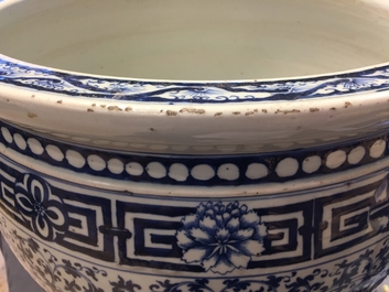 A pair of Chinese blue and white lotus scroll fishbowls, 19th C.