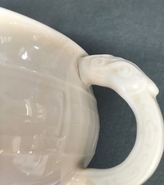 A round Chinese Dehua blanc de Chine censer with moulded and underglaze decoration, 19th C.