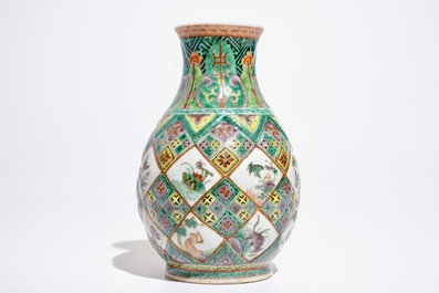 A Chinese famille verte vase with exotic animals, 19th C.