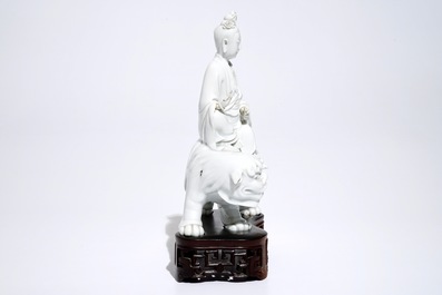 A Chinese Dehua blanc de Chine model of Guanyin seated on a Buddhist lion, 19th C.