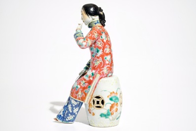 A Chinese famille rose model of a lady on a garden seat, 19th C.