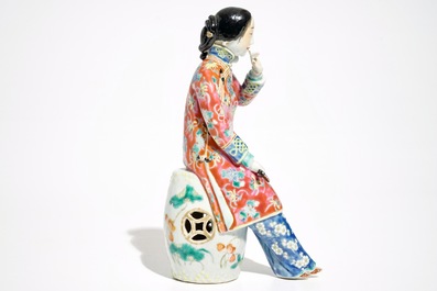 A Chinese famille rose model of a lady on a garden seat, 19th C.