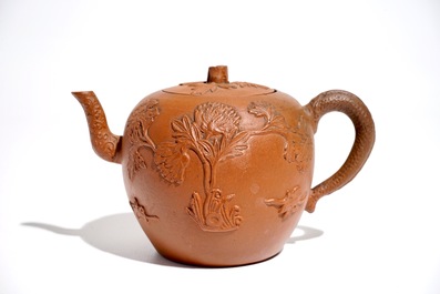 Een Chinese Yixing steengoed theepot met reli&euml;fdecor, Kangxi