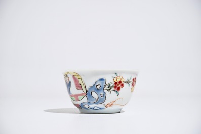 A Chinese famille rose cup and saucer with figures in a garden, Yongzheng