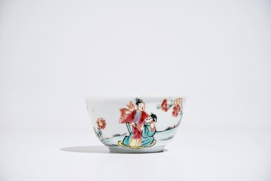 A Chinese famille rose cup and saucer with figures in a garden, Yongzheng