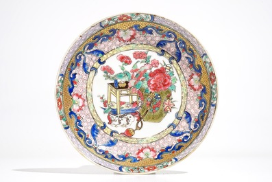 A Chinese famille rose cup and saucer with a cat, Yongzheng