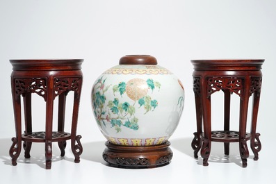 A Chinese famille rose jar and cover, with a pair of wooden stands, 19/20th C.