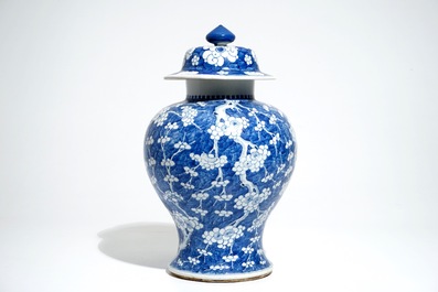 A Chinese blue and white baluster vase and cover with prunus on cracked ice, Kangxi