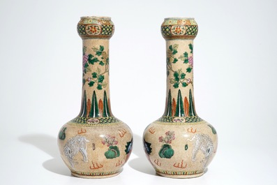 A pair of Chinese crackle-glazed bottle vases with kylins and elephants, 19th C.