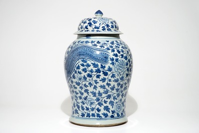 A tall Chinese blue and white baluster jar and cover with a phoenix, 19th C.