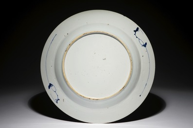 A large Chinese blue and white dish with a boy on a terrace, Qianlong