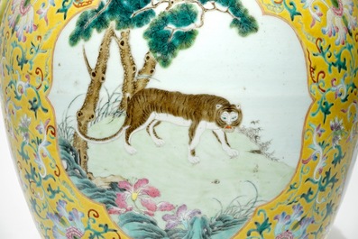 A tall Chinese famille rose yellow-ground vase with a tiger, Qianlong mark, 19th C.