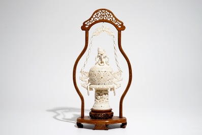 A Chinese encrusted ivory vase on wooden stand, early 20th C.
