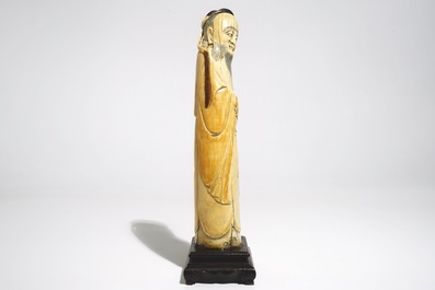 A Chinese ivory figure of the immortal Han Zhongli, on wooden base, late Ming