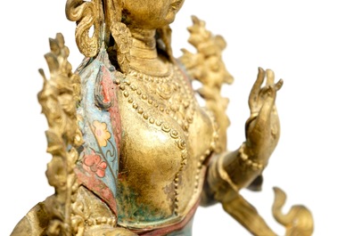 A large Chinese gilt bronze and cloisonn&eacute; figure of Green Tara, 19th C.