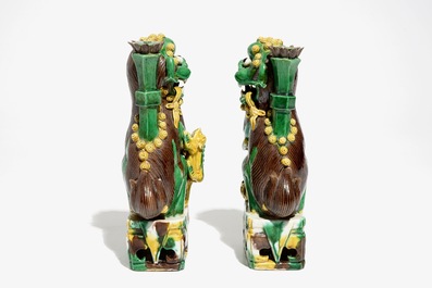 A pair of Chinese verte biscuit joss stick holders shaped as Buddhist lions, Kangxi