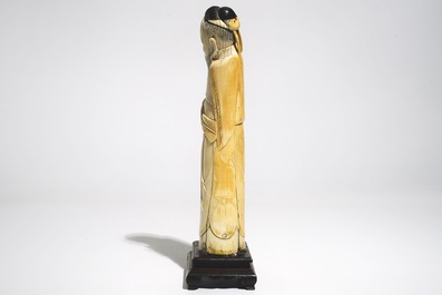 A Chinese ivory figure of the immortal Han Zhongli, on wooden base, late Ming