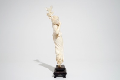 A Chinese ivory figure of a lady with a butterfly, early 20th C.