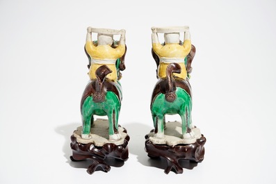 A pair of Chinese verte biscuit joss stick holders shaped as warriors on Buddhist lions, Kangxi