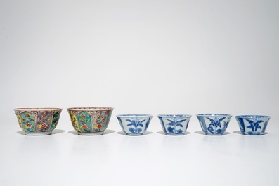 A pair of Chinese famille verte cups and saucers and four blue and white cups, Kangxi