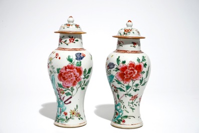 A pair of Chinese famille rose covered vases and four saucers, Yongzheng/Qianlong