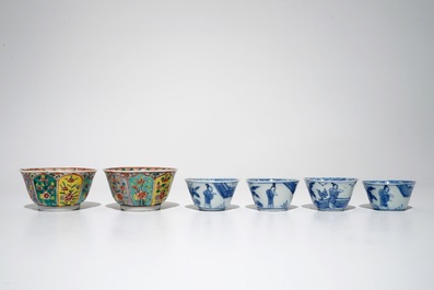 A pair of Chinese famille verte cups and saucers and four blue and white cups, Kangxi