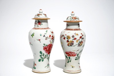 A pair of Chinese famille rose covered vases and four saucers, Yongzheng/Qianlong