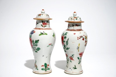 A pair of Chinese famille rose covered vases and four saucers, Yongzheng/Qianlong