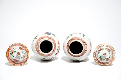 A pair of Chinese famille rose covered vases and four saucers, Yongzheng/Qianlong