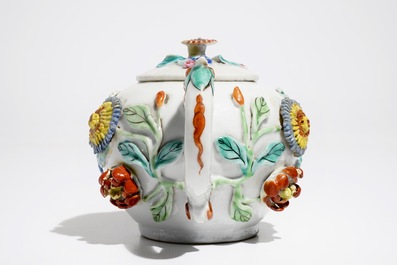 A Chinese famille rose teapot on stand with applied decoration, Yonzheng