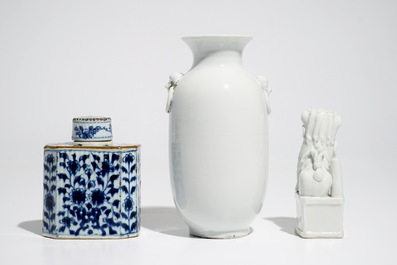 A Chinese Dehua blanc de Chine temple lion, a vase and a blue and white tea caddy, Kangxi and later