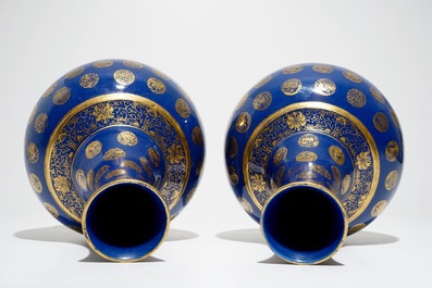 A pair of Chinese gilt-decorated powder blue-ground bottle vases, Qianlong mark, Guangxu