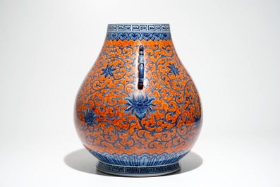 Un vase de forme hu en porcelaine de Chine aux rinceaux de pivoines sur fond rouge corail, marque de Yongzheng, 20&egrave;me