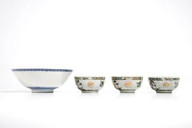 Three Chinese famille verte crackle glaze cups and saucers and a blue and white soft paste bowl, Kangxi